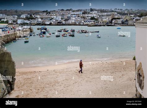 Uk Weather A Man Walking Alone On The Beach On A Rainy Chilly