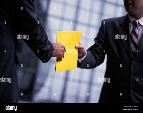 Businessmen Passing Documents Stock Photo Alamy