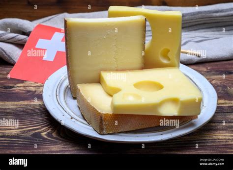 Cheese Collection Swiss Emmentaler Gruyere Appenzeller Cheeses And Flag Of Switzerland Close