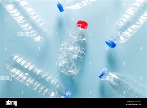 Crushed Plastic Water Bottles With Blue Caps Standing Around Crushed