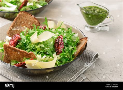 Salad With Frisee Lettuce Sun Dried Tomatoes Cheese Bread Chips And