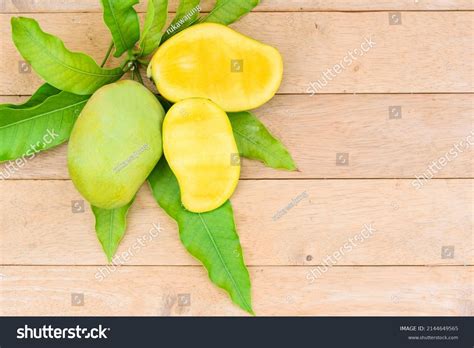 Closeup Yellow Mango On Wood Plate Stock Photo 2144649565