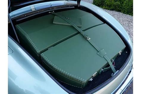 An Open Trunk Of A Car With Luggage In It S Back Seat And The Hood Up