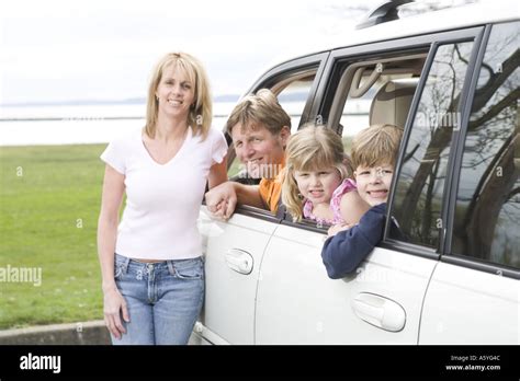 Happy family together in minivan Stock Photo - Alamy