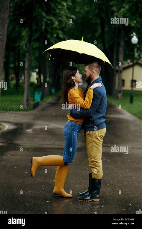 Love couple kissing in park, summer rainy day Stock Photo - Alamy