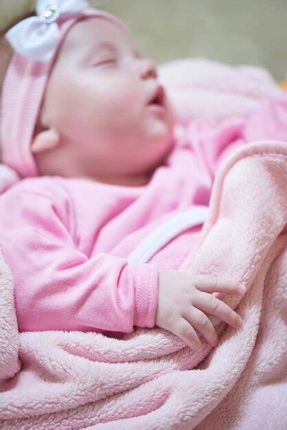 Premium Photo Newborn Baby Girl Sleeping In Bed At Home