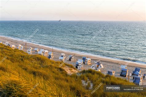 Germany, Schleswig-Holstein, Sylt, beach and empty hooded beach chairs ...