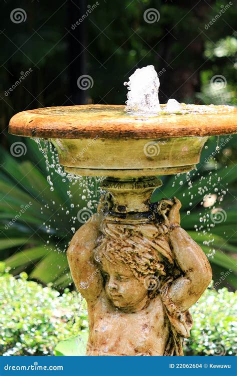 Bubbling Angel Sculpture Fountain In The Garden Stock Photo Image Of