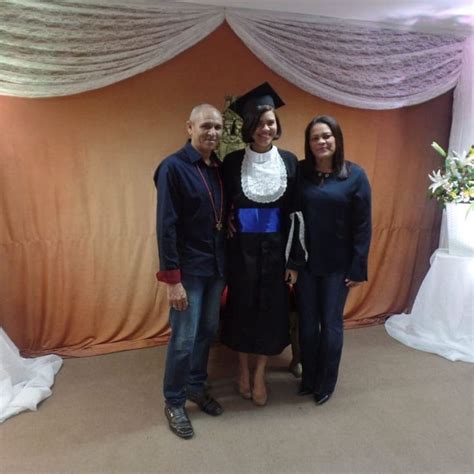 Three People Standing In Front Of A Backdrop