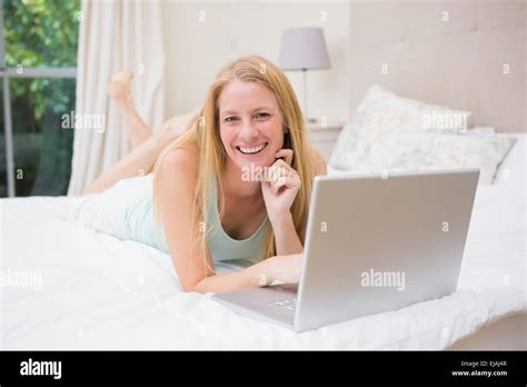 Happy Blonde Using Laptop On Bed Stock Photo Alamy