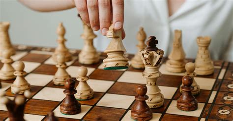Person Playing Chess Game on Chess Board · Free Stock Photo