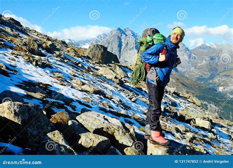 Hiker With Backpacks Reaches The Summit Of Mountain Peak Success