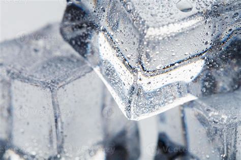 Ice Cube With Water Drops Close Up In Macro On A White Background