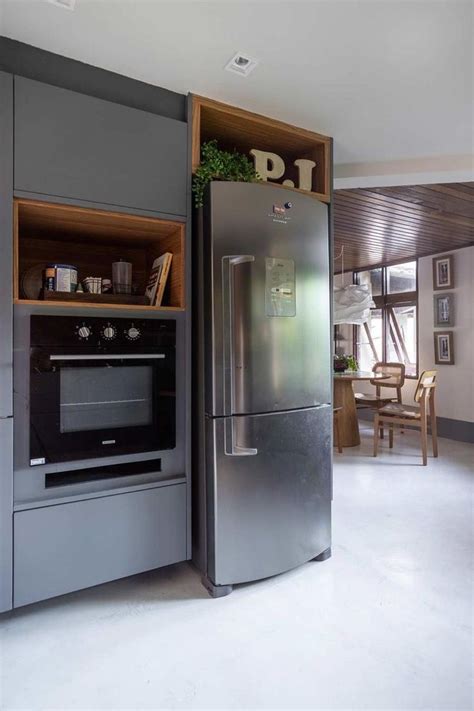 A Stainless Steel Refrigerator Freezer Sitting Inside Of A Kitchen