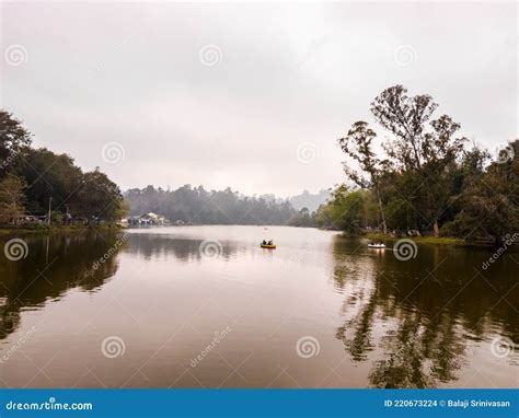 The Tranquil Waters Of The Lake Surrounded By Green Trees In The Hill Station Of Kodaikanal In