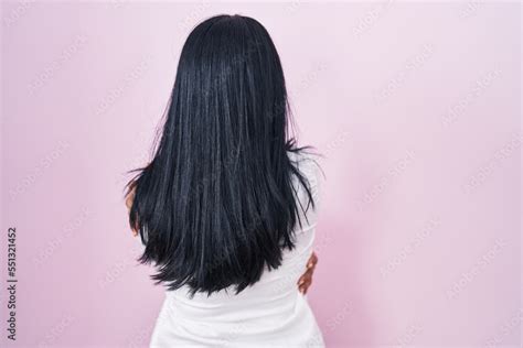 Mature Hispanic Woman Standing Over Pink Background Hugging Oneself Happy And Positive From