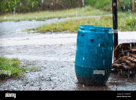 Blue Trash Can Placed In The Middle Of A Dirt Road In A Poor