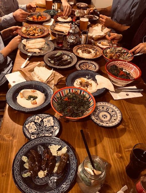 Premium Photo Cropped Image Of People Eating Food On Table