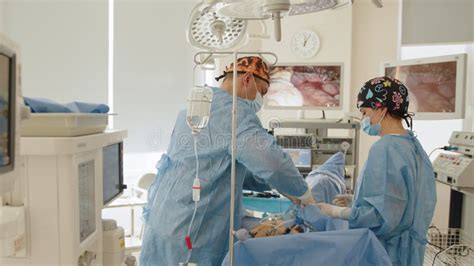 Male Surgeon Preforming Operation Uterus Removal In Hospital Operating