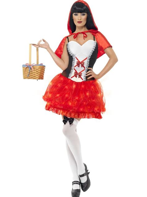 A Woman In A Red And White Costume Holding A Basket