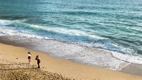 Girls Take Pictures On The Beach Aerial View K Stock Footage Videohive