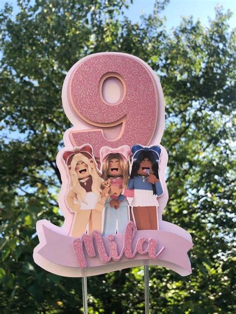 There Is A Pink Cake Topper With The Number Nine And Two Women On It