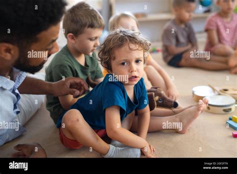 Little boy pre school teacher talking hi-res stock photography and ...