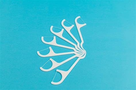 Premium Photo | Floss with handle on blue background