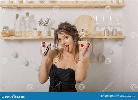 Very Beautiful And Cheerful Woman Holding Cakes In Her Hands And