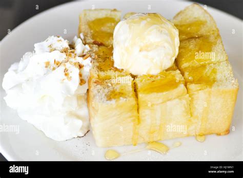 Honey Toast With Vanilla Ice Cream Whipped Cream And Syrup Dish Stock