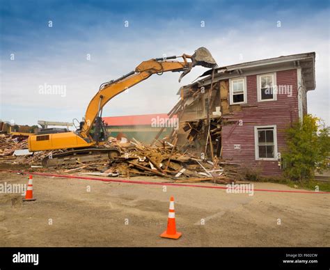 Demolition house yellow construction machine hi-res stock photography and images - Alamy