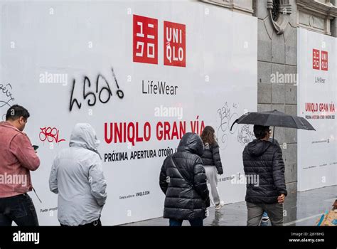 April 23, 2022, Madrid, Spain: Pedestrians walk past a new upcoming Japanese clothing brand ...