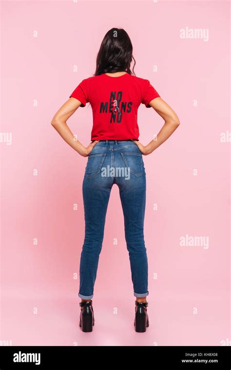 Vertical Back View Image Of Brunette Woman Posing With Arms On Hips
