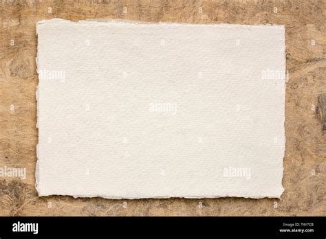 Small Sheet Of Blank White Khadi Rag Paper From South India Against