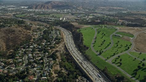 76k Stock Footage Aerial Video Flying Over Homes To Approach I 10 And