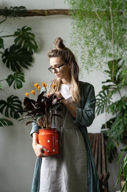 Premium Photo Beautiful Woman Standing By Potted Plant