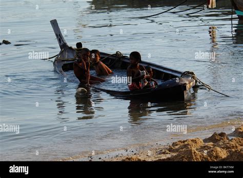 Children Playing In A Semi Sunken Fishing Boatchao Leh Sea Gypsy