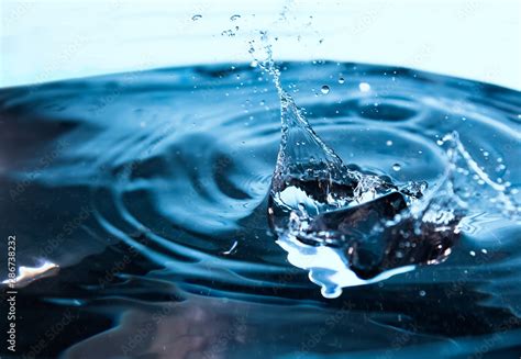 Water Splash Ice Cubes Falling Into The Blue Water Splash Of Ice