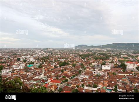 Aerial view of dense city and population of Bandar Lampung cityscape with horizon and coastline ...