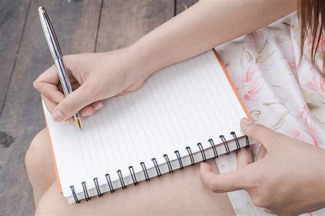 Premium Photo Close Shot Of A Human Hand Writing Something On The Paper