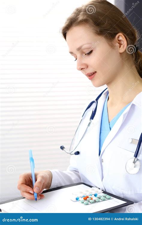 Woman Doctor At Work At Hospital Young Female Physician Write