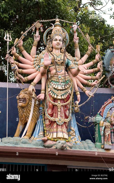 Pavarti A Multi Armed Hindu Goddess Stands On A Temple Roof In