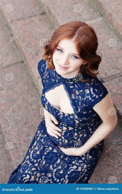 Beautiful Young Red Hair Pregnant Woman Sitting On Stairs Royalty Free