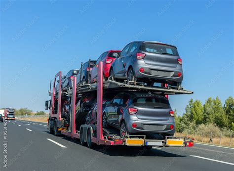 Car carrier trailer with cars on bunk platform. Car transport truck on ...