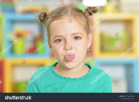 Portrait Little Girl Making Funny Faces Stock Photo 1154981098