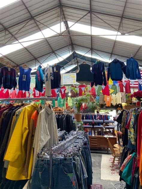 An Open Market With Clothes Hanging From The Ceiling