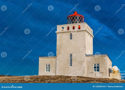 The Dyrholaey Lighthouse in Iceland Stands Guard in Stormy Skies Stock Photo - Image of ...