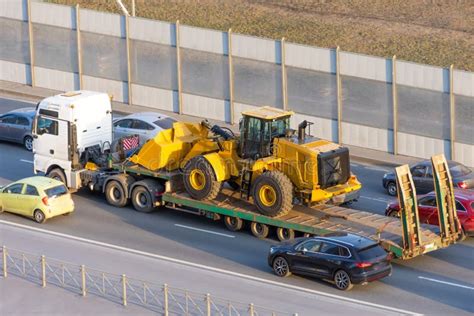 Truck With A Long Trailer Platform For Transporting Heavy Machinery