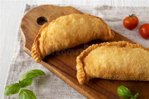 Homemade Deep Fried Italian Panzerotti Calzone On A Rustic Wooden Board