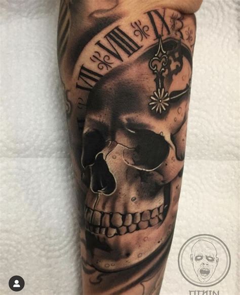 A Man S Arm With A Clock And Skull Tattoo On It